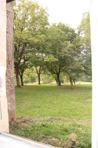 a view of a field of trees from a window at Domaine de la Clauzade in Saint-Germain-les-Vergnes