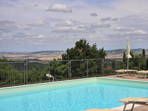a swimming pool with a view of the hills at Villetta Pia in Contignano