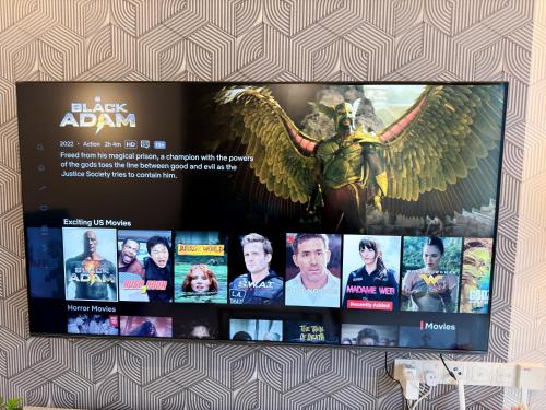 a tv screen with a picture of a superhero at MidValley Southkey Mosaic 6-9pax Netflix-SmartTV70inch in Johor Bahru