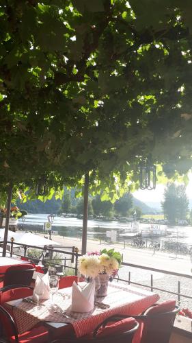 a table with flowers on it with a view at Hotel Restaurant Alte Stadtmauer in Beilstein
