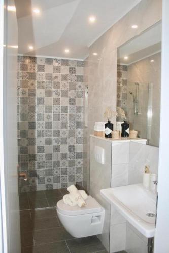 a bathroom with a toilet and a sink at Vila Marinessa in Hvar