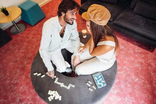 a man and a woman sitting on a skateboard at Stay Hotel Porto Centro Trindade in Porto