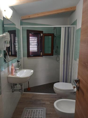a bathroom with a sink and a toilet and a shower at B&B da Giovanna Dimora del Turista in Santa Maria del Cedro