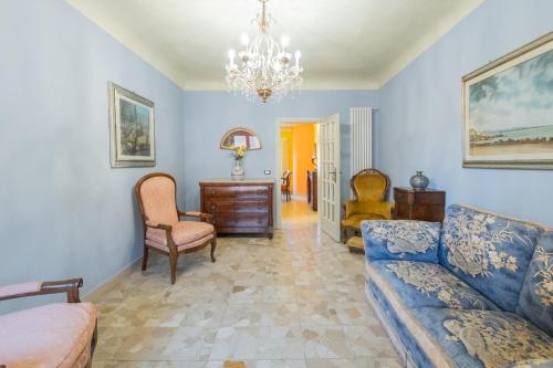 a living room with a couch and a chair at Casa Torre San Romano in Lucca
