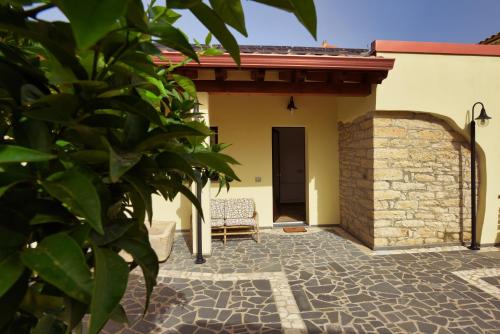 a patio with a chair and a building at Casa di Nonna Rosa e Nonno Ciccito in Masullas