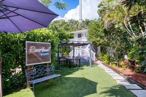 a patio with an umbrella and a table and chairs at Riverbend Apartments by Lowkl in Fort Lauderdale