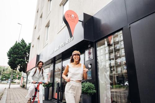 a woman is standing outside of a store at Stay Hotel Porto Centro Trindade in Porto