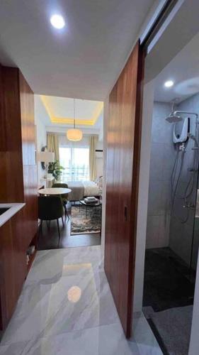 a room with a hallway with a living room and a bathroom at Elegant & Unique space The Loop 21st floor in Cagayan de Oro