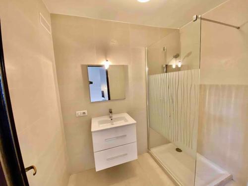 a white bathroom with a sink and a shower at MarinesAppartement, La terrasse Tropézienne in Saint-Tropez