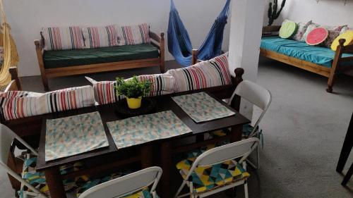 a living room with a table and a couch at AEROHOSTEL Brasil in Guarulhos