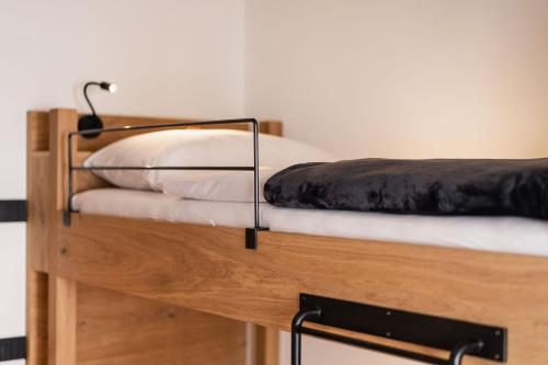 a bunk bed with two pillows on top of it at Chalet Lumis in San Vigilio Di Marebbe