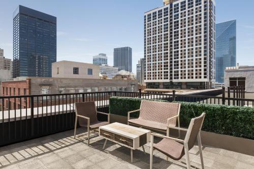 a patio with two chairs and a table on a roof at The American Hotel Atlanta Downtown, Tapestry Collection by Hilton in Atlanta