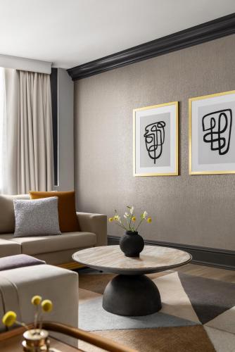 a living room with a couch and a table at The American Hotel Atlanta Downtown, Tapestry Collection by Hilton in Atlanta