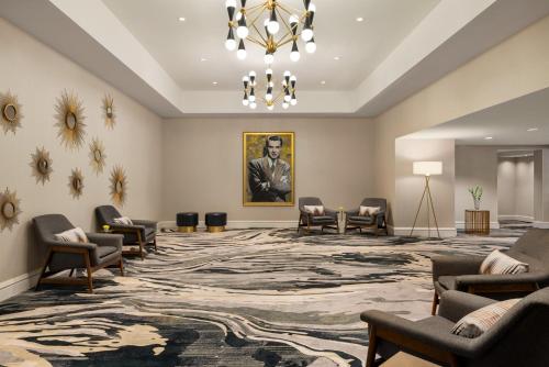 a waiting room with chairs and a large rug at The American Hotel Atlanta Downtown, Tapestry Collection by Hilton in Atlanta
