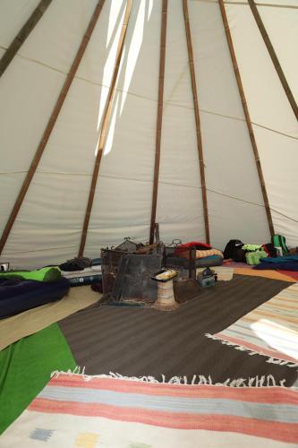 a tent with mats and other items on the floor at @gatetothewild in Coreglia Ligure