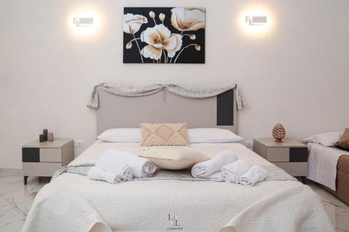 a bedroom with a bed with towels on it at La Loggia Suite in Marsala