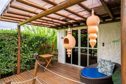 a porch with a wooden deck with a wooden pergola at Dolphin Hotel in Fernando de Noronha