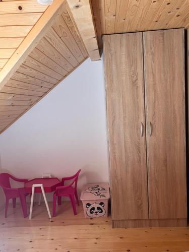 a room with a wooden cabinet and a table at Apartman Marjanović Tara, Kaluđerske bare in Kaludjerske Bare
