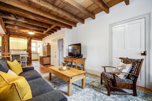 a living room with a couch and a table at The Marigold - Gorgeously remodelled PEC farmhouse in West Lake
