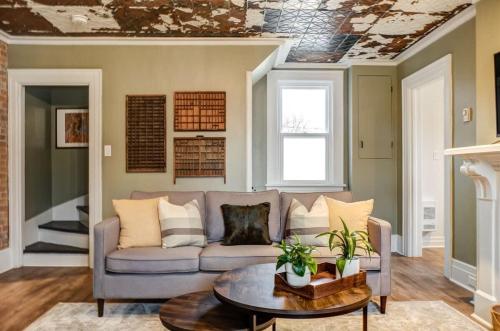 a living room with a couch and a table at The Marigold - Gorgeously remodelled PEC farmhouse in West Lake