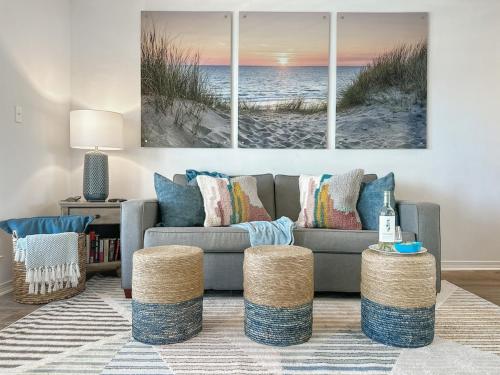 a living room with a couch and a beach at Sunrise Destin-ation Beach view Heated Pool in Destin