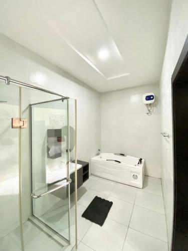a bathroom with a glass shower and a sink at Urban apartment in Lagos