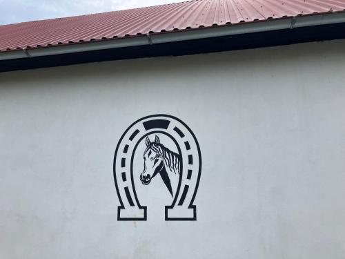 a horse logo on the side of a building at Apartment Yorkshire in Bujanov