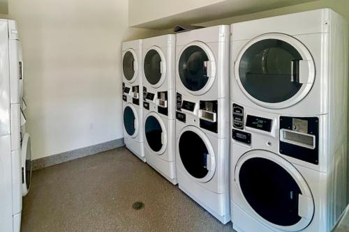 four washing machines are lined up against a wall at Après Ski Hideaway, Unit 30A in Snowmass
