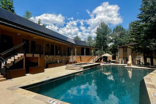 a large swimming pool in front of a building at Après Ski Hideaway, Unit 30A in Snowmass