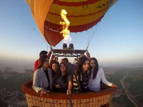 a group of people riding a hot air balloon at Mak tours in Luxor