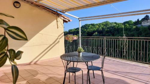 a table and two chairs on a balcony at Alloggio panoramico in Caprarola