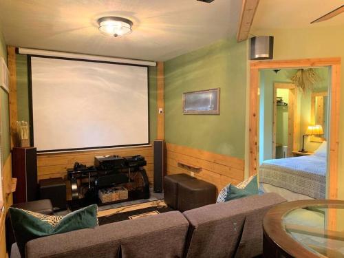 a living room with a couch and a large window at The River Haven - Sleeps 32 - on Guadalupe River in Seguin