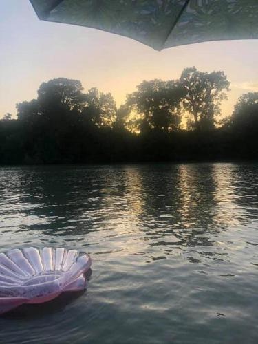 a boat in the water on a lake at The River Haven - Sleeps 32 - on Guadalupe River in Seguin