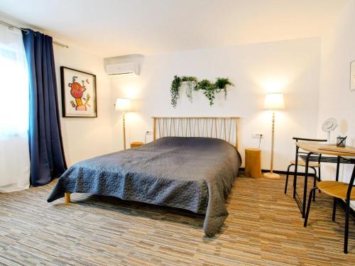 a bedroom with a bed and a table in it at Feel Good in Ravna Gora
