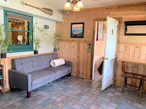 a living room with a couch and a door at The River Haven - Sleeps 32 - on Guadalupe River in Seguin