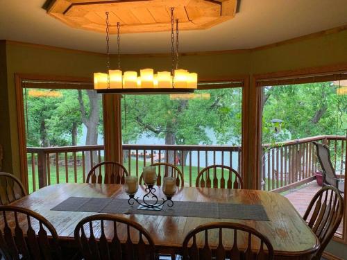 a dining room with a table and chairs on a porch at The River Haven - Sleeps 32 - on Guadalupe River in Seguin