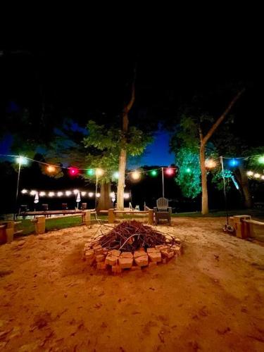 a large fire pit in the dirt at night at The River Haven - Sleeps 32 - on Guadalupe River in Seguin