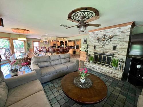 a living room with a couch and a fireplace at The River Haven - Sleeps 32 - on Guadalupe River in Seguin