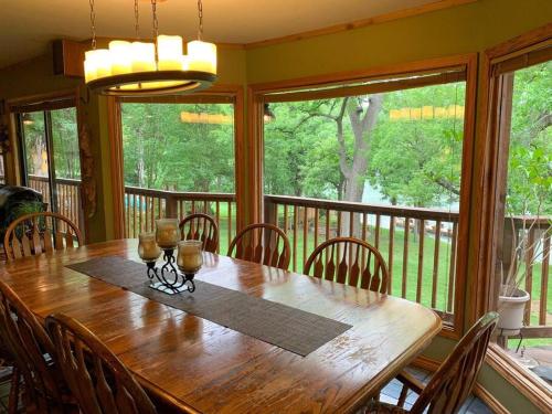 a dining room with a wooden table and chairs at The River Haven - Sleeps 32 - on Guadalupe River in Seguin