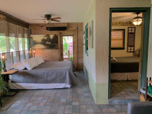 a bedroom with a large bed and a mirror at The River Haven - Sleeps 32 - on Guadalupe River in Seguin