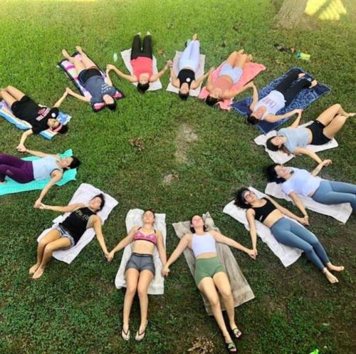 a group of women sitting in a circle on the grass at The River Haven - Sleeps 32 - on Guadalupe River in Seguin