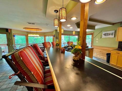 a dining room with a long table and chairs at The River Haven - Sleeps 32 - on Guadalupe River in Seguin