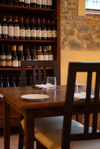 a wooden table with a glass of wine on it at The Monna Lisa Resort in Arezzo