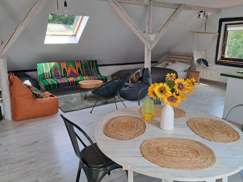 a living room with a table with sunflowers on it at Małopolskie Swojskie in Olszyny
