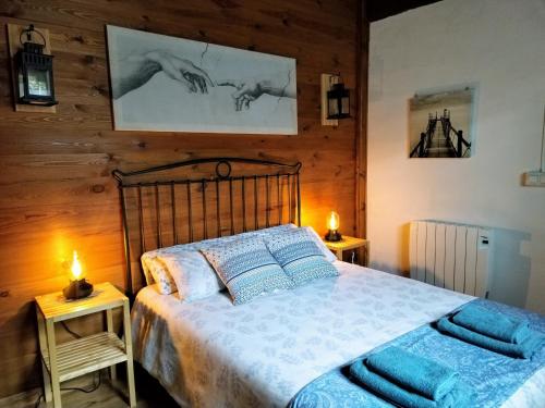 a bedroom with a bed with two lamps on tables at Aldaetxea in Biáñez