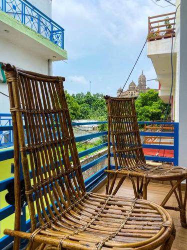 a pair of chairs sitting on a balcony at Comfort & Cozy, Villa in Orchha