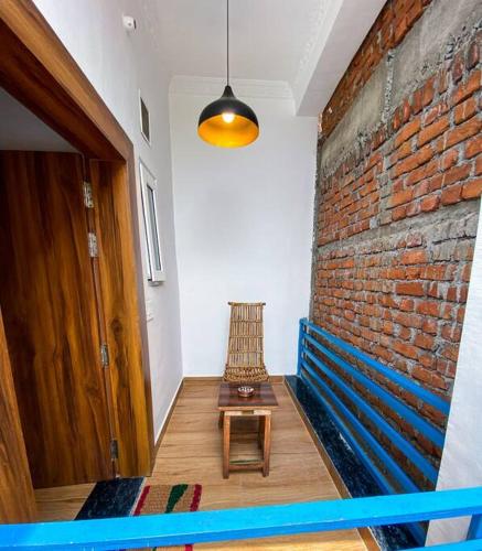 a room with a bench and a brick wall at Comfort & Cozy, Villa in Orchha