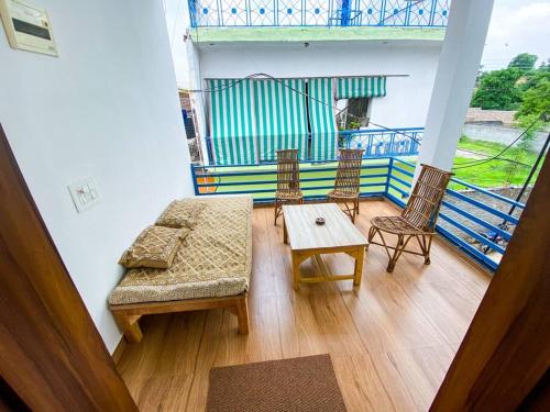 a living room with a couch and two chairs and a table at Comfort & Cozy, Villa in Orchha