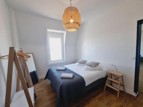 une chambre avec un lit avec deux serviettes dessus dans l'établissement Belle vue sur les sablons, à Saint-Malo