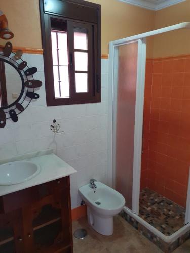 a bathroom with a shower and a sink and a toilet at Matalascañas MAR in Matalascañas